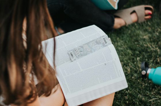 Teenagers participating in a Bible study discussion with a youth leader