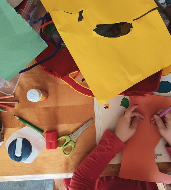Children gathered around a table engaged in Bible-based activities and crafts